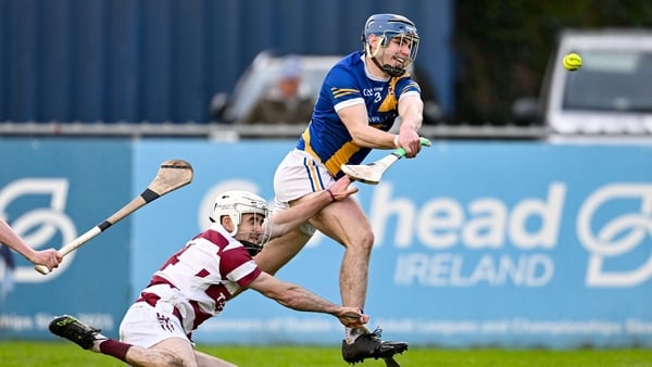 Vince Morgan of Loughrea scores his side's second goal despite the attention of Conor McAllister of Slaught Néill - All-Ireland club hurling semi-final, December 2025