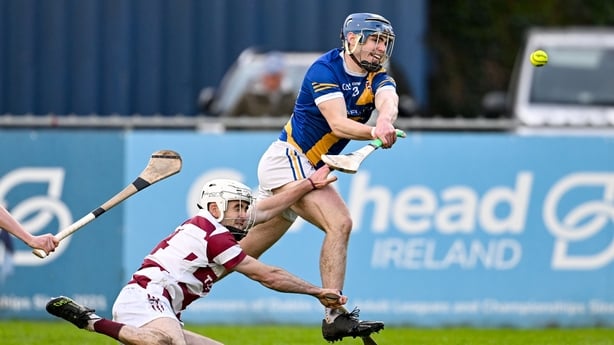 Vince Morgan of Loughrea scores his side's second goal despite the attention of Conor McAllister of Slaught Néill - All-Ireland club hurling semi-final, December 2025