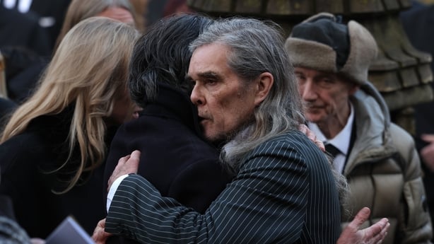 (L-R) John Squire and Ian Brown of The Stone Roses hug at the funeral of their friend and bandmate Gary Mounfield, also known as Mani, at Manchester Cathedral on 22 December, 2025 