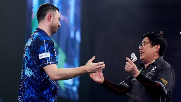 England's Luke Humphries (left) celebrates defeating Singapore's Paul Lim at 2026 World Darts Championship