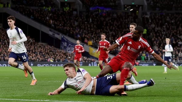 Alexander Isak of Liverpool is tackled by Micky van de Ven of Tottenham Hotspur as he scores the opening goal during the Premier League match between Tottenham Hotspur and Liverpool at Tottenham Hotspur Stadium on December 20, 2025 in London, England.