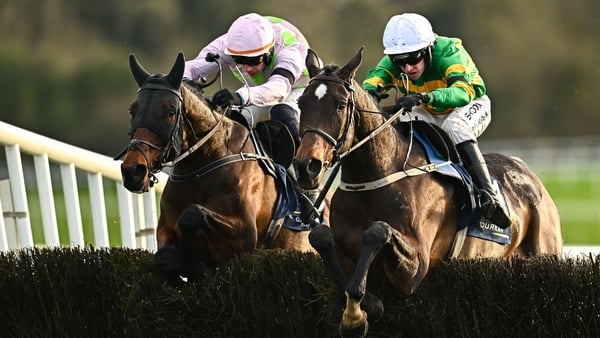 Fact To File, right, with Mark Walsh, jumps the last on their way to finishing second, from eventual first place Gaelic Warrior, left, with Paul Townend up, during the John Durkan Memorial Punchestown Steeplechase during day two of the Punchestown Premier