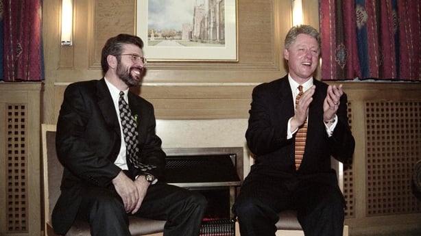 US President Bill Clinton (R) shares a light-hearted moment with Sinn Fein leader Gerry Adams during a reception at Queen's University in Belfast on November 30, 1995. President Clinton is the first US President to visit Northern Ireland. (Photo by Luke FRAZZA / AFP) (Photo by LUKE FRAZZA/AFP via Ge