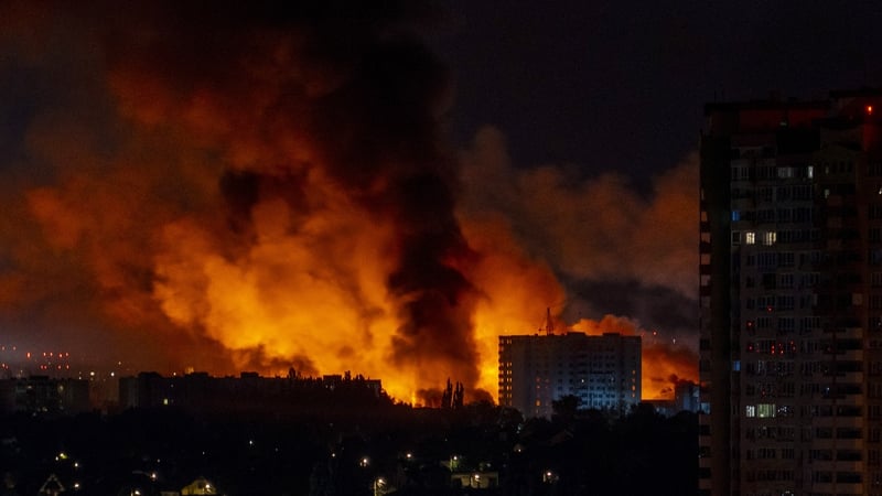 Flames and smoke billow from buildings during mass Russian drones and missile strikes on the Ukraine's capital on 4 July