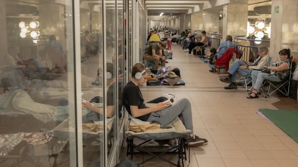 People take shelter at a metro station during Russian air attacks in Kyiv