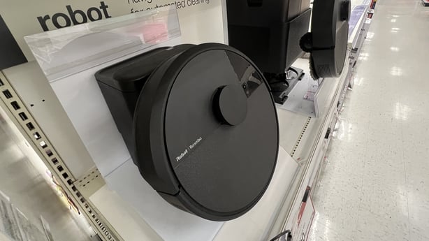 MIAMI, FLORIDA - DECEMBER 15: A display of Roomba robot vacuums made by iRobot sits on a store shelf on December 15, 2025, in Miami, Florida. iRobot has filed for bankruptcy after its failed merger with Amazon. In its bankruptcy filing, it noted that it owes U.S. Customs and Border Protection $3.4 m