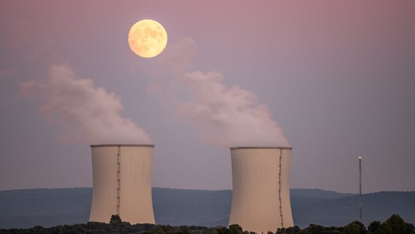 An almost full moon of October, known as Hunter's Moon, rises over the cooling towers of the Trillo Nuclear Power Plant in Guadalajara, Spain