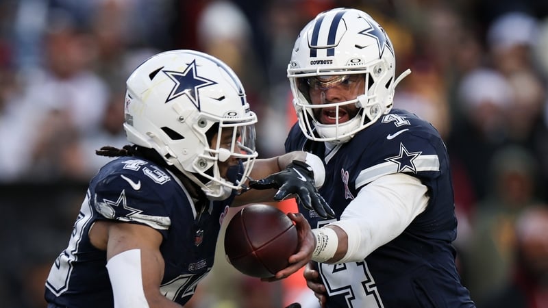 Dak Prescott of the Dallas Cowboys hands the ball to Malik Davis