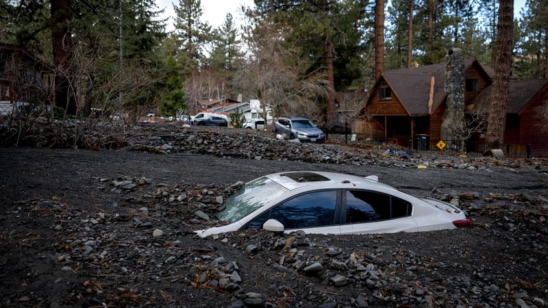 Debris from storm damage covers a car in Wrightwood, California