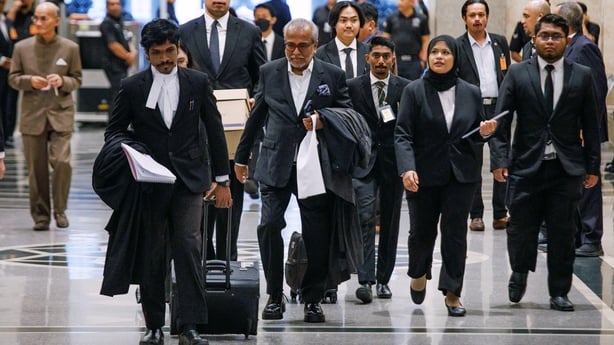 Members of former Malaysia prime minister Najib Razak's legal team arrive at court for the verdict