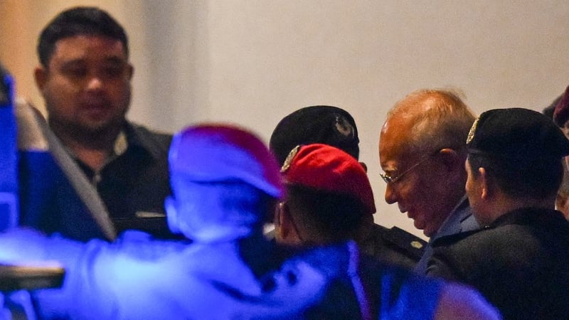 Najib Razak (2R) leaves court after his conviction