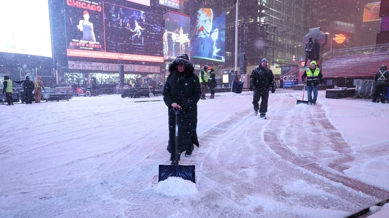 Workers clear away snow in Times Square, New York