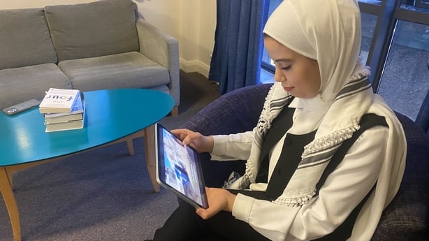 Ghada watching her RTÉ report from July