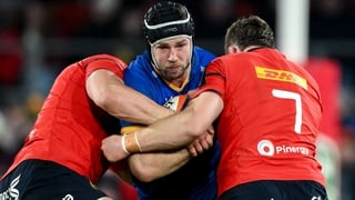 27 December 2025; Caelan Doris of Leinster is tackled by Gavin Coombes, left, and Jack O'Donoghue of Munster during the United Rugby Championship match between Munster and Leinster at Thomond Park in Limerick. Photo by Brendan Moran/Sportsfile