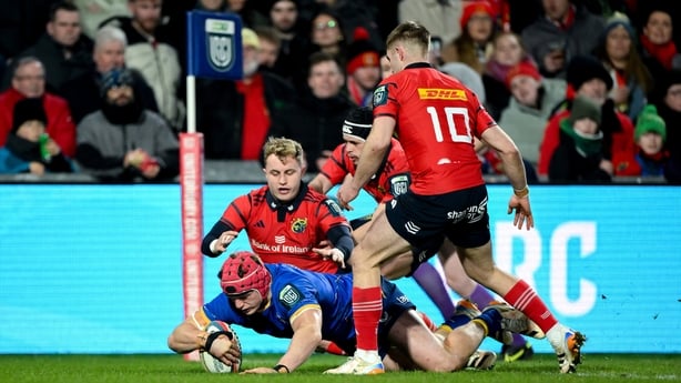27 December 2025; Josh van der Flier of Leinster dives over to score his side's first try despite the efforts of Craig Casey, left, and Jack Crowley of Munster during the United Rugby Championship match between Munster and Leinster at Thomond Park in Limerick. Photo by Brendan Moran/Sportsfile