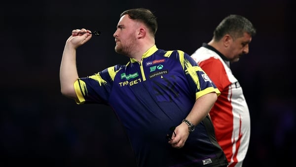 LONDON, ENGLAND - DECEMBER 27: Luke Littler of England throws against Mensur Suljovic of Austria (obscured) during the Round Three match between Luke Littler and Mensur Suljovic at Alexandra Palace on December 27, 2025 in London, England. (Photo by James