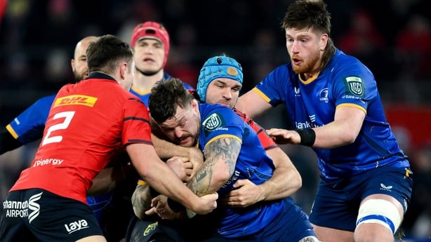 27 December 2025; Andrew Porter of Leinster is tackled by Lee Barron, left, and Tadhg Beirne of Munster during the United Rugby Championship match between Munster and Leinster at Thomond Park in Limerick. Photo by Brendan Moran/Sportsfile