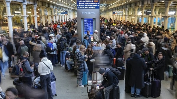 Travellers are pictured at St. Pancras station in London