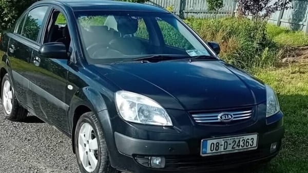 Black Kia Rio 08 D 24363 front and side from driver side of actual car