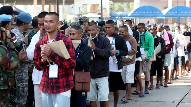 People line up next to police