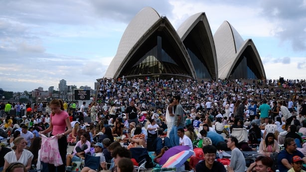 Thousands of people gathered with the Sydney Opera House in the background