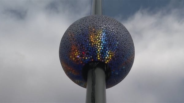 A large, multi-coloured crystal ball on a silver pole in New York City’s Times Square