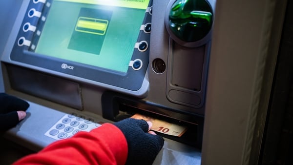 A man withdraws euro notes from an ATM in Sofia, Bulgaria