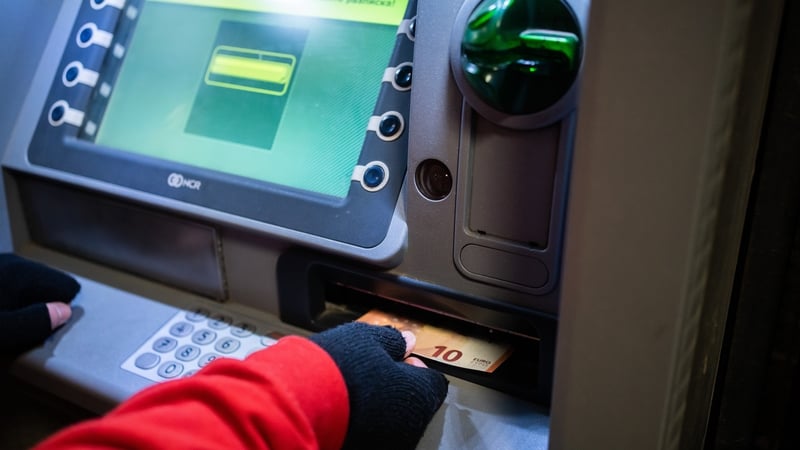 A man withdraws euro notes from an ATM in Sofia