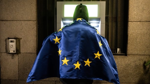 A man withdraws euro cash from an ATM in Sofia, Bulgaria 