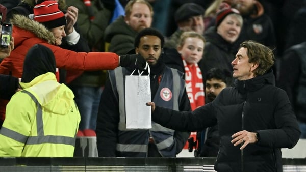 Tottenham Hotspur head coach Thomas Frank receives a gift from a Bretford fan at the Gtech Community Stadium