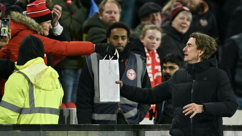 Tottenham Hotspur head coach Thomas Frank receives a gift from a Bretford fan at the Gtech Community Stadium