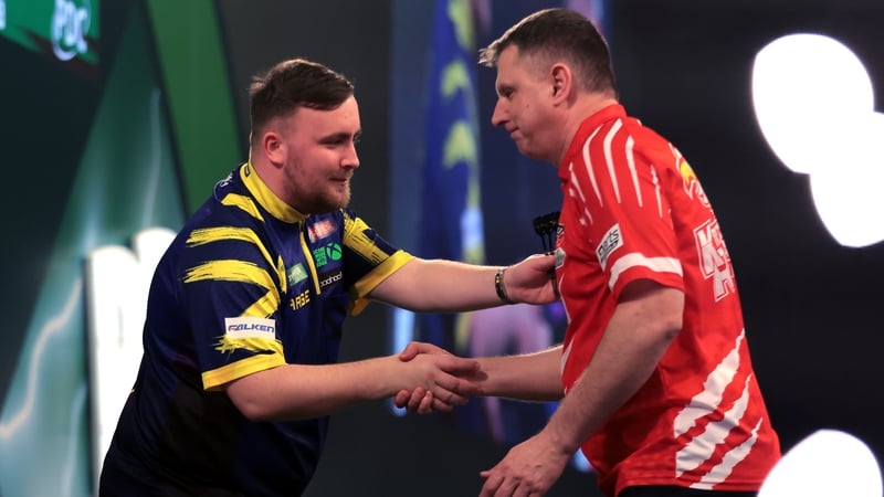Luke Littler and Krzysztof Ratajski shake hands after the reigning world champion's 5-0 win