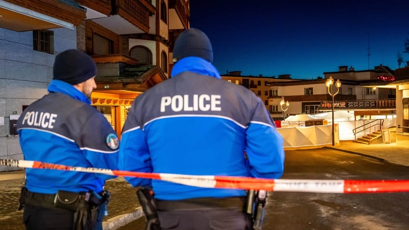 Police control access to the street where the fire tore through a crowded bar in the Alpine ski resort town of Crans-Montana