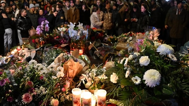 CRANS-MONTANA, SWITZERLAND - JANUARY 01: Mourners gather to leave flowers and candles at the scene after a fire broke out overnight at Le Constellation bar on January 01, 2026 in Crans-Montana, Switzerland. According to authorities, the fire began around 1:30 AM local time, with reports that 47 peop