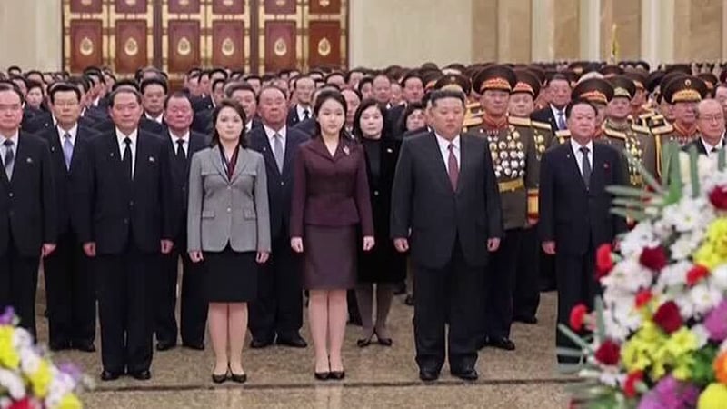 Kim Ju Ae (in maroon coloured suit) is seen standing between her parents