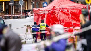 Police officers control the entrance to the bar Le Constellation where a fire happened at the venue during New Year's Eve