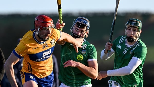 Peter Duggan of Clare is tackled by Vince Harrington and Matthew Fitzgerald of Limerick during the Co-Op Superstores Munster Senior Hurling League match between Clare and Limerick at Páirc an Dálaigh in Tulla, Clare. Photo by Ray McManus/Sportsfile