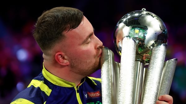 LONDON, ENGLAND - JANUARY 03: Luke Littler of England kisses the Sid Waddell trophy after defeating Gian van Veen of the Netherlands (not pictured) during the 2025/26 Paddy Power World Darts Championship Final match between Luke Littler and Gian van Veen