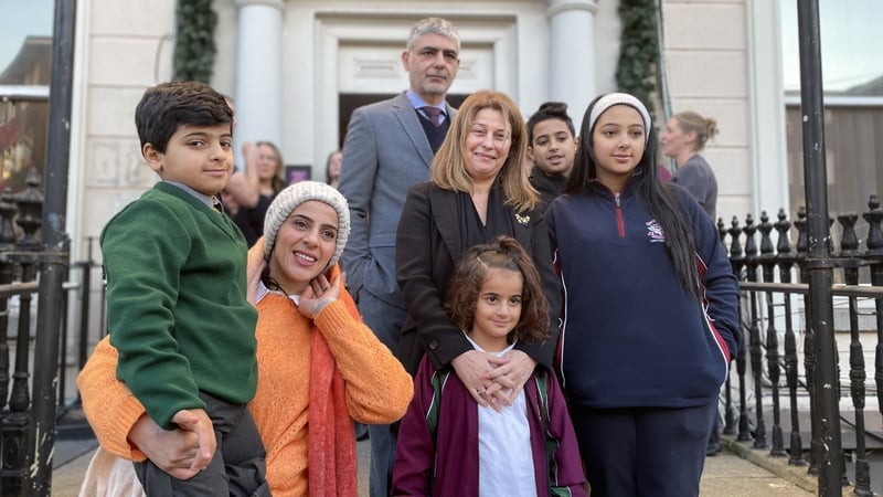 Buchra Abdul-Bari holds her son Mohammed with her daughter Ghazal, son Zainaldeen and daughter Kinzy, with Palestinian ambassador Dr Jilan Wahba Abdalmajid and members of the Medevac programme