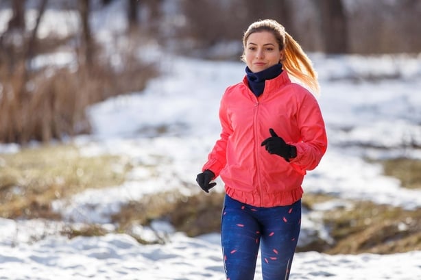 A woman going for a run on a snowy day