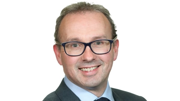 Picture of a smiling business man in glasses and in a suit