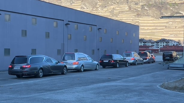 hearses are seen lined in a row