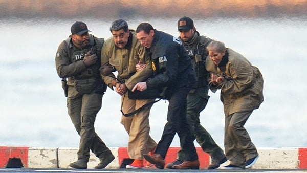 Nicolas Maduro and his wife, Cilia Flores, are seen in handcuffs after landing at a Manhattan helipad, escorted by heavily armed Federal agents as they make their way into an armored car en route to a Federal courthouse in Manhattan