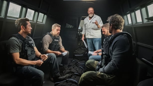 (L-R) Actors Steven Yeun as Detective Mike Ro and Matt Damon as Lieutenant Dane Dumars, writer-director Joe Carnahan, and Ben Affleck as Detective Sergeant JD Byrne and Kyle Chandler as DEA Agent Mateo 'Matty' Nix on the set of The Rip Photo: Claire Folger/Netflix