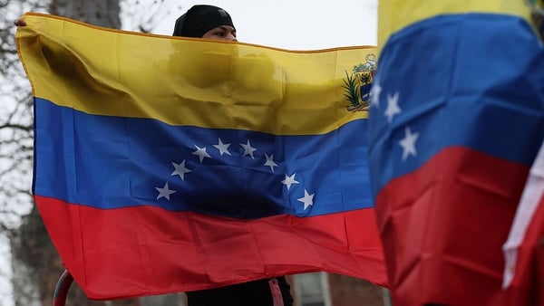 NEW YORK, NEW YORK - JANUARY 05: People hold Venezuelan flags outside of the Daniel Patrick Moynihan United States Courthouse before the arraignment of President of Venezuela Nicolas Maduro's and first lady Cilia Flores on January 05, 2026 in New York Cit