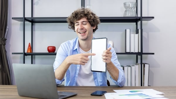Caucasian man is working at his home office while presenting the new project using digital tablet in the online meeting with his team and customer for freelance and entrepreneur business