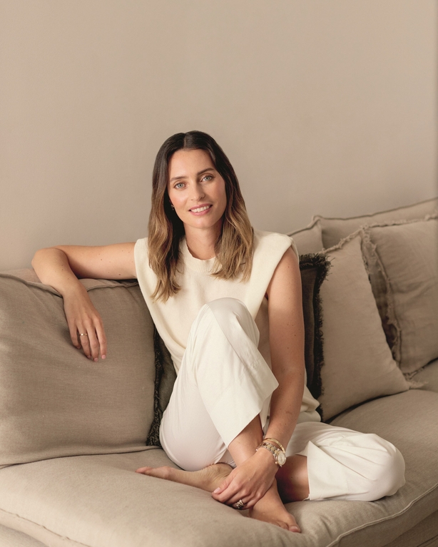 Ella Mills sitting on a couch