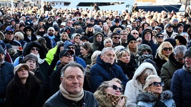 Mourners and fans watch on a screen the live broadcast of the funeral ceremony for late French actress Brigitte Bardot, at Notre-Dame de l'Assomption church in Saint-Tropez