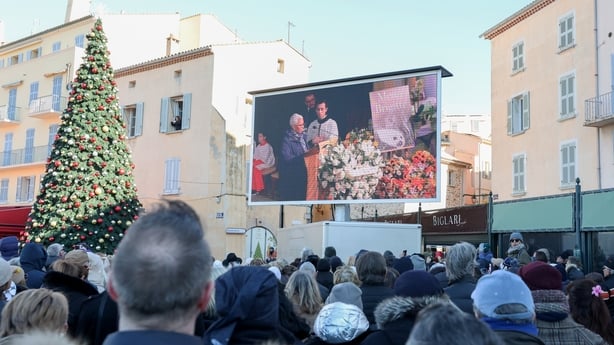 People gather to watch Brigitte Bardot's funeral service on a big screen in Saint-Tropez