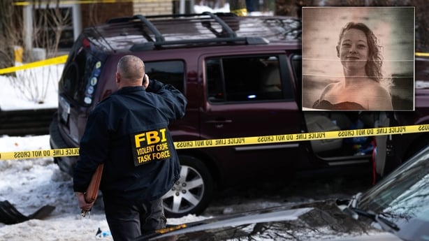 photograph shows a man wearing a jacket with FBI on the back in front of a crime scene tape with a photo of a woman at the top right hand corner